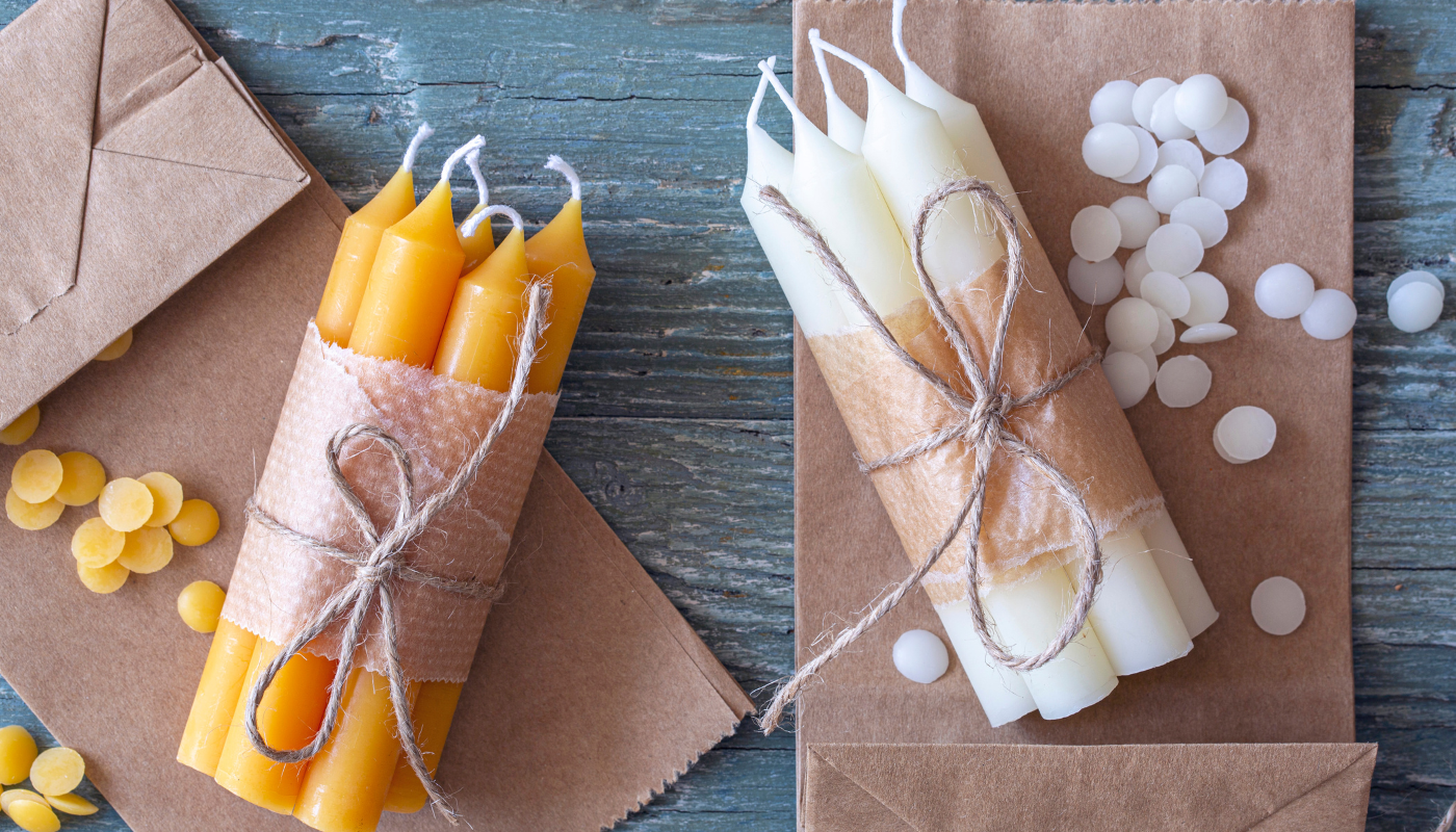 Two bundles of long stem candles wrapped with twine. 